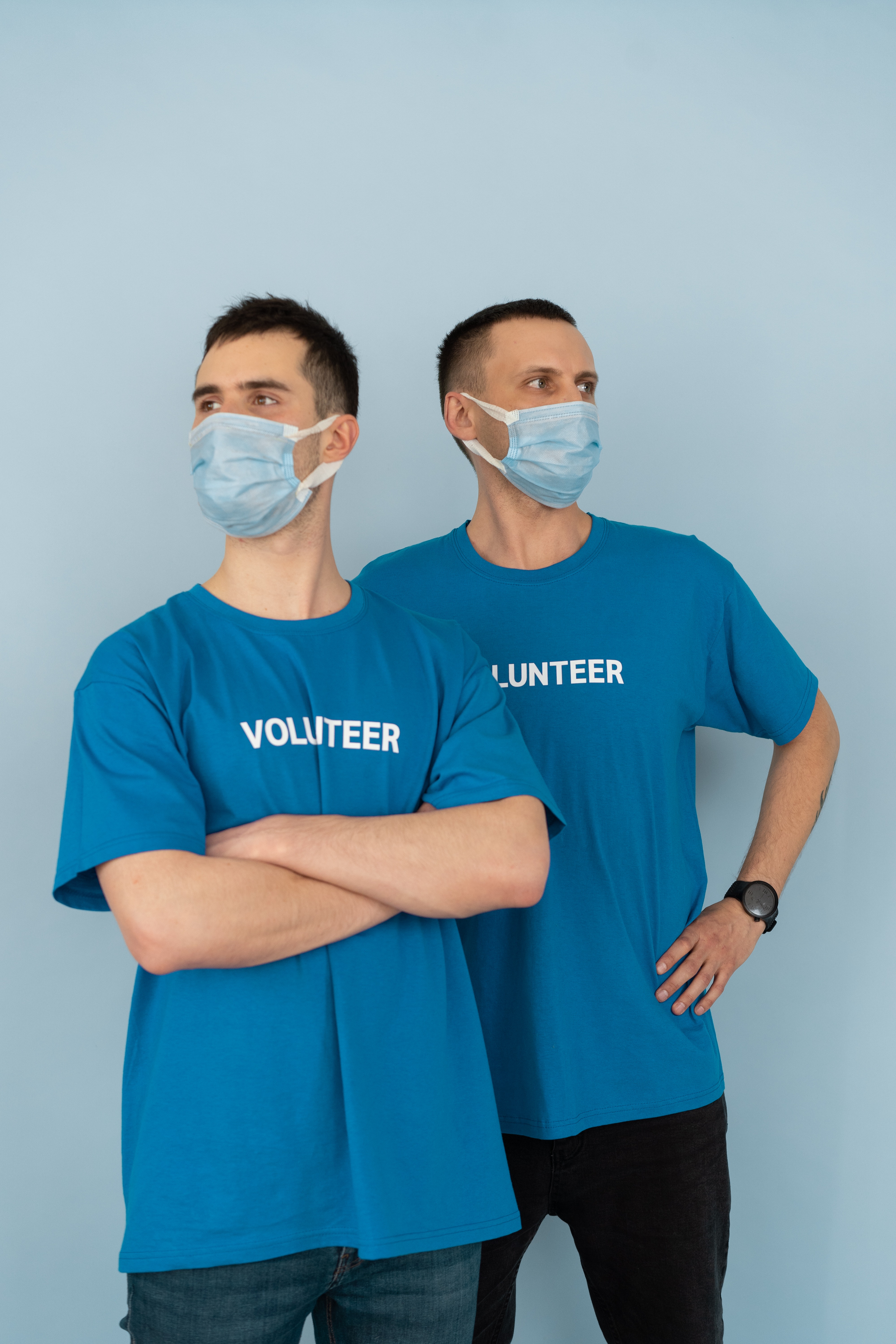 2 men in blue volunteering tops